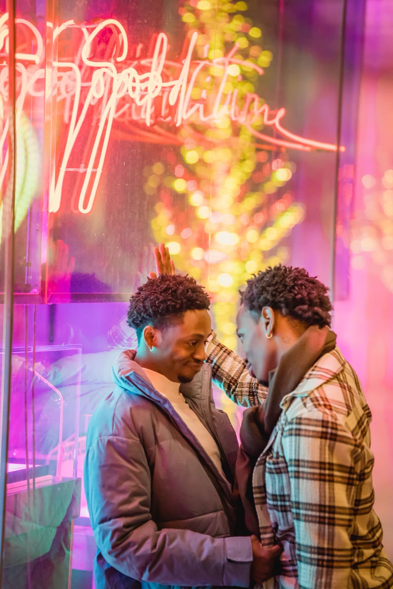 A couple sharing a close moment under neon lights